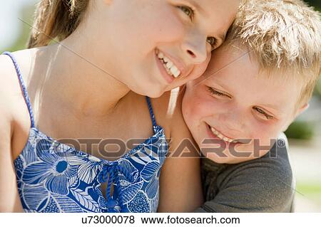 Brother and sister laughing together View Large Photo Image Stock Photo - Brother and sister laughing together. Fotosearch