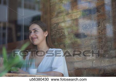 Stock Image - Businesswoman having meeting in coffee bar, London. Fotosearch