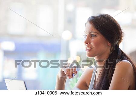 Stock Photography - Businesswoman having meeting in coffee bar, London. Fotosearch