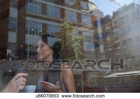 Stock Image - Businesswomen having meeting in coffee bar, London. Fotosearch