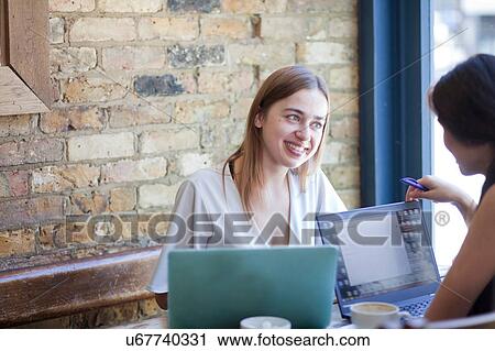Businesswomen having meeting in coffee bar, London View Large Photo Image Stock Image - Businesswomen having meeting in coffee bar, London. Fotosearch
