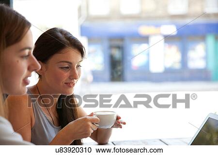 Stock Image - Businesswomen having meeting in coffee bar, London. Fotosearch