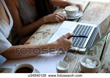 Stock Photograph - Businesswomen having meeting in coffee bar, London. Fotosearch