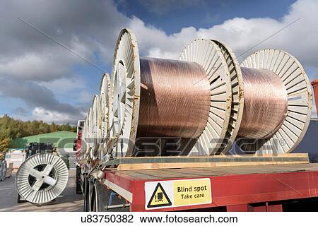 Stock Image - Cable reels on truck at cable storage facility. Fotosearch