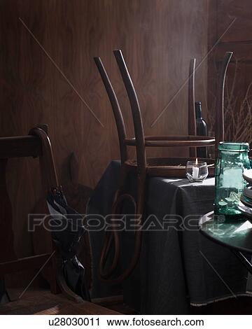 Chair upside down on table in restaurant View Large Photo Image Stock Image - Chair upside down on table in restaurant. Fotosearch