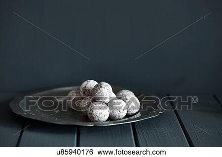 Stock Photograph - Chocolate and champagne truffles on silver plate. Fotosearch