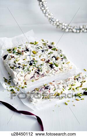 Stock Image - Christmas present of nut and dried fruit nougat. Fotosearch