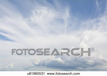 Stock Image - Cirrus and Cumulus clouds on blue sky. Fotosearch