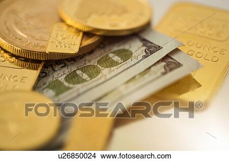 Picture - Close-up of gold coins and banknotes. Fotosearch