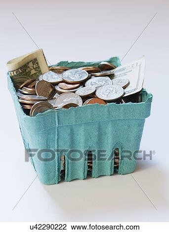 Stock Image - Coins and banknotes in carton box on on white surface. Fotosearch