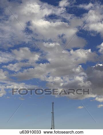 Communication tower against cloudy sky View Large Photo Image Stock Image - Communication tower against cloudy sky. Fotosearch