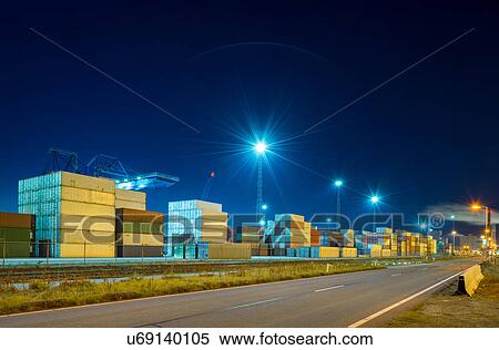 Stock Photography - Containers stacked in terminal at Rotterdam harbour, Netherlands. Fotosearch