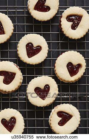 Cookies with heart shapes on baking sheet View Large Photo Image Stock Photography - Cookies with heart shapes on baking sheet. Fotosearch