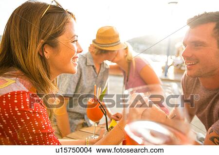 Picture - Couple chatting at waterfront restaurant, Majorca, Spain. Fotosearch