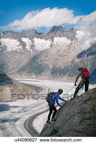 Couple climbing up ridge over Aletsch Glacier, Canton Wallis, Switzerland View Large Photo Image Stock Photo - Couple climbing up ridge over Aletsch Glacier, Canton Wallis, Switzerland. Fotosearch