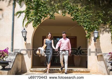 Couple coming down stairs outside boutique hotel, Majorca, Spain View Large Photo Image Stock Image - Couple coming down stairs outside boutique hotel, Majorca, Spain. Fotosearch