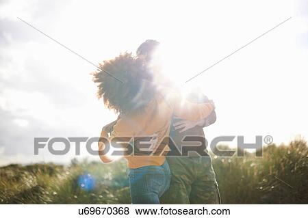 Stock Photo - Couple dancing on grassy sand dune. Fotosearch