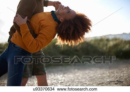 Picture - Couple dancing on sand dune. Fotosearch
