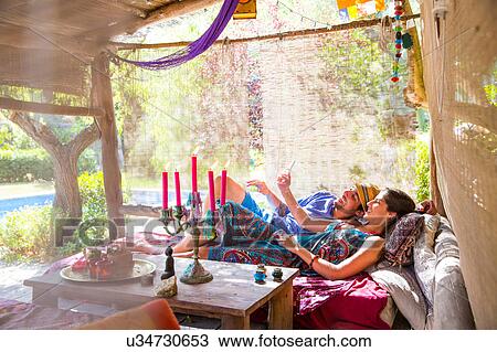 Couple lying down taking selfie View Large Photo Image Stock Image - Couple lying down taking selfie. Fotosearch