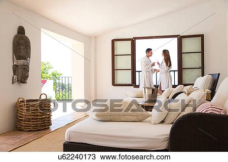 Stock Image - Couple making a champagne toast in boutique hotel suite, Majorca, Spain. Fotosearch