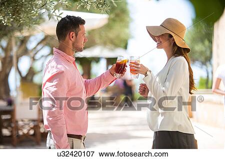 Stock Photo - Couple making a toast on arrival to boutique hotel, Majorca, Spain. Fotosearch
