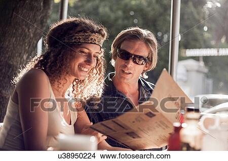 Couple reading menu at sidewalk cafe, Cape Town, South Africa View Large Photo Image Picture - Couple reading menu at sidewalk cafe, Cape Town, South Africa. Fotosearch
