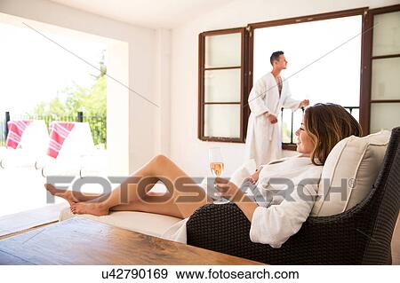 Stock Photo - Couple relaxing with champagne in boutique hotel suite, Majorca, Spain. Fotosearch