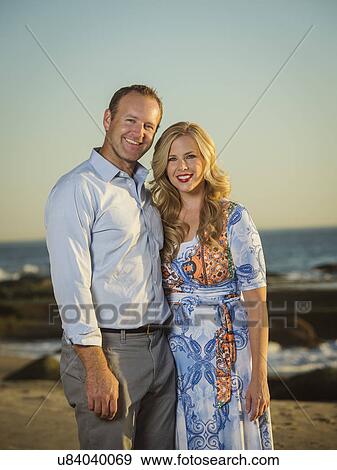 Couple standing on beach View Large Photo Image Stock Photo - Couple standing on beach. Fotosearch