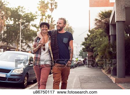 Couple strolling on street, Cape Town, South Africa View Large Photo Image Stock Photo - Couple strolling on street, Cape Town, South Africa. Fotosearch
