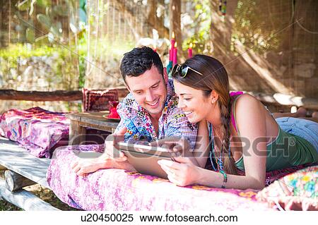 Stock Photography - Couple using digital tablet smiling. Fotosearch