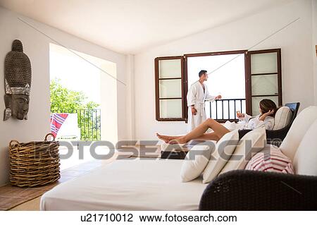 Couple with champagne in boutique hotel suite, Majorca, Spain View Large Photo Image Stock Image - Couple with champagne in boutique hotel suite, Majorca, Spain. Fotosearch