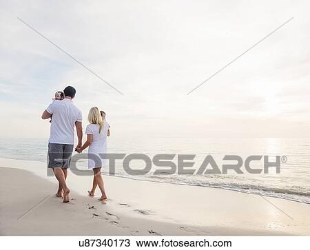 Couple with twins (2-5 months) walking along seashore View Large Photo Image Stock Image - Couple with twins (2-5 months) walking along seashore. Fotosearch