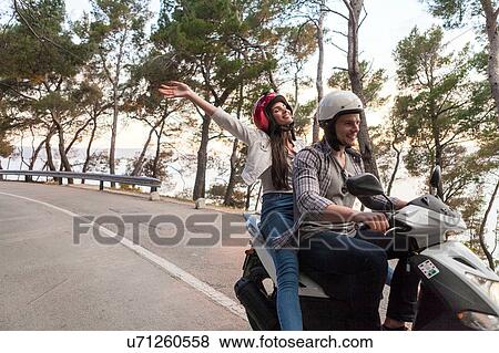Stock Photo - Couples riding moped on rural road, Split, Dalmatia, Croatia. Fotosearch