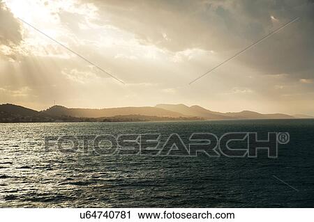 Croatia, Ugljan island, Sunbeams shining on sea surface View Large Photo Image Stock Image - Croatia, Ugljan island, Sunbeams shining on sea surface. Fotosearch