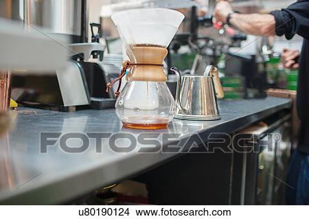 Picture - Cropped shot of male barista preparing coffee in cafe. Fotosearch