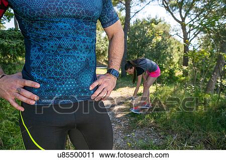 Stock Image - Cropped shot of male runner with hands on hips in park, Split, Dalmatia, Croatia. Fotosearch