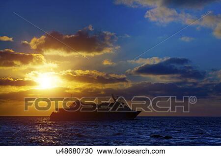 Stock Image - Cruise liner at sunset. Fotosearch