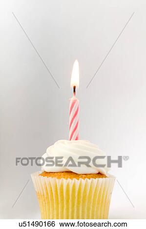 Stock Photograph - Cupcake with birthday candle. Fotosearch