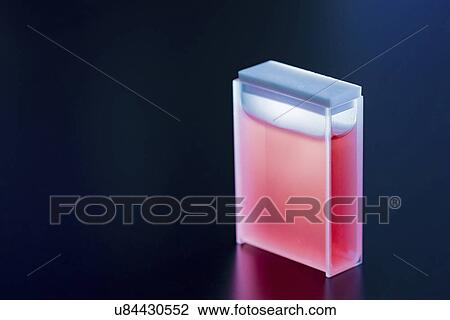 Stock Image - Cuvette containing red sample. Fotosearch