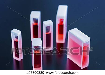 Stock Image - Cuvettes containing red samples. Fotosearch