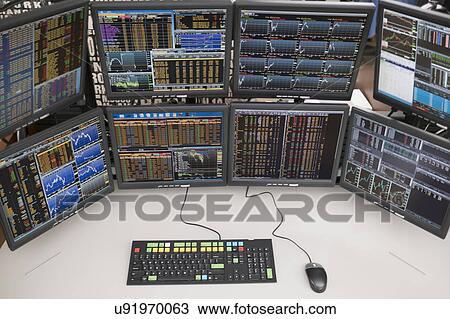 Stock Image - Desk with arrangement of computer monitors. Fotosearch