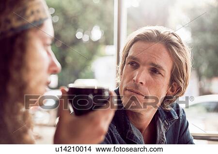 Picture - Distracted couple at sidewalk cafe. Fotosearch
