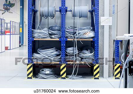 Picture - Electrical cables on shelf in engineering plant. Fotosearch
