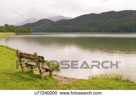 Empty bench by lake, Bavaria, Germany View Large Photo Image Stock Image - Empty bench by lake, Bavaria, Germany. Fotosearch