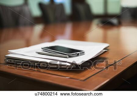 Empty conference table with mobile devices and documents View Large Photo Image Picture - Empty conference table with mobile devices and documents. Fotosearch
