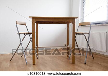 Empty table and chairs in a room View Large Photo Image Stock Image - Empty table and chairs in a room. Fotosearch