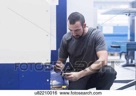Engineer using allen key in engineering plant View Large Photo Image Stock Photograph - Engineer using allen key in engineering plant. Fotosearch