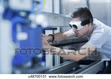 Engineer, wearing safety goggles, working in engineering plant View Large Photo Image Stock Image - Engineer, wearing safety goggles, working in engineering plant. Fotosearch