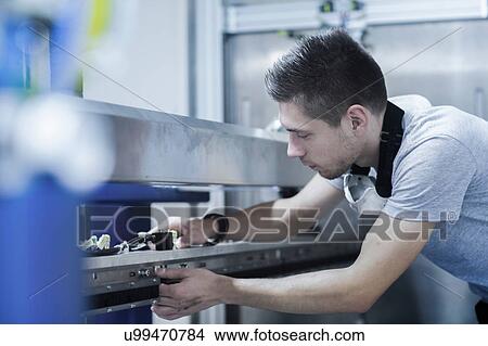 Picture - Engineer working in engineering plant. Fotosearch