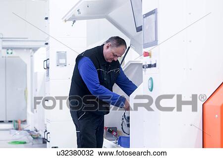 Stock Image - Engineer working in engineering plant. Fotosearch